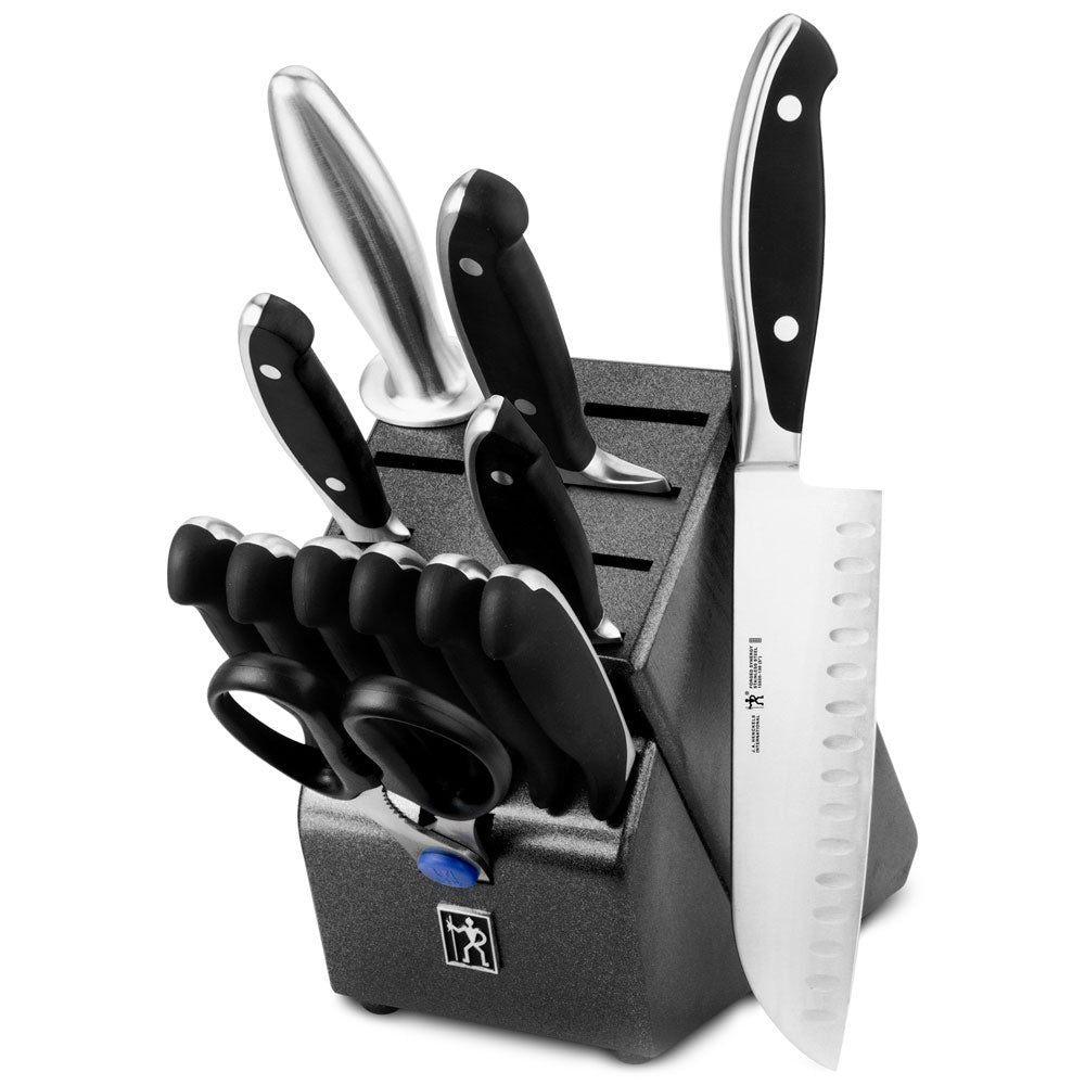 Knife block set with black-handled knives and gray storage block, including chef knife