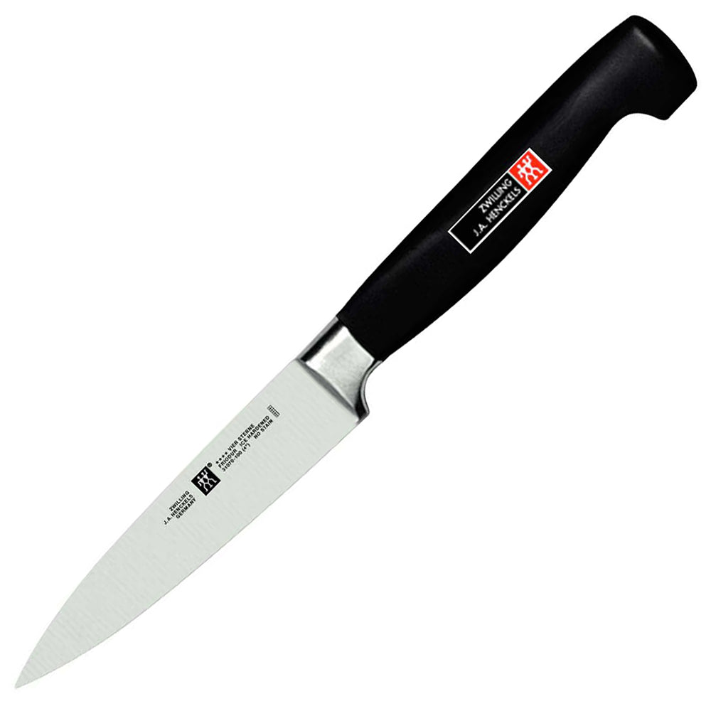 Zwilling J.A. Henckels Four Star 4-inch paring knife with black handle and stainless blade