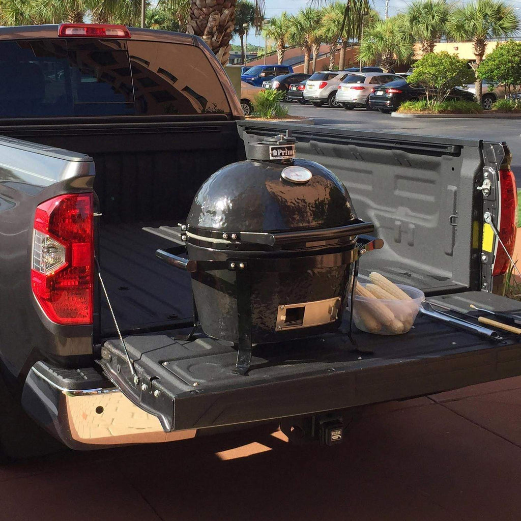 Portable grill cradle on vehicle platform, black steel legs and front access panel