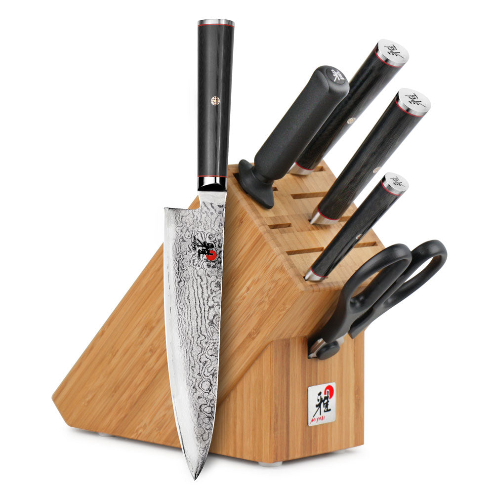 Wooden knife block with black-handled knives and one chef knife
