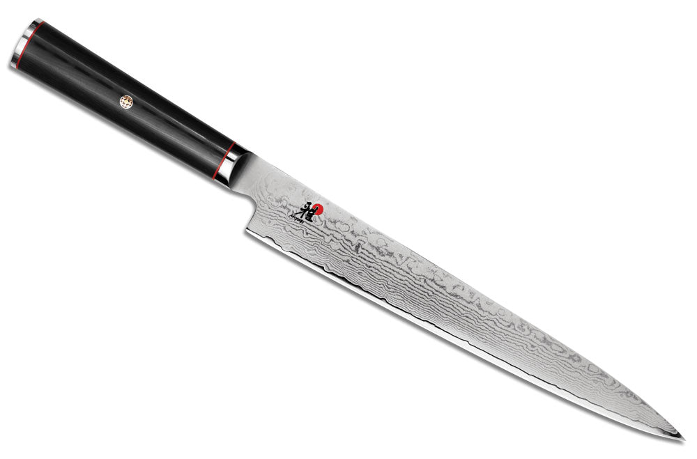 Damascus slicing knife with black handle and red accent ring