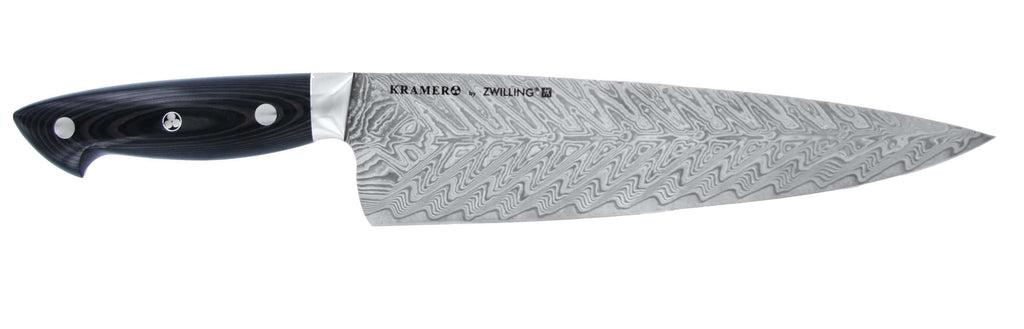 Chef's knife with black handle and patterned stainless Damascus blade, pointed tip