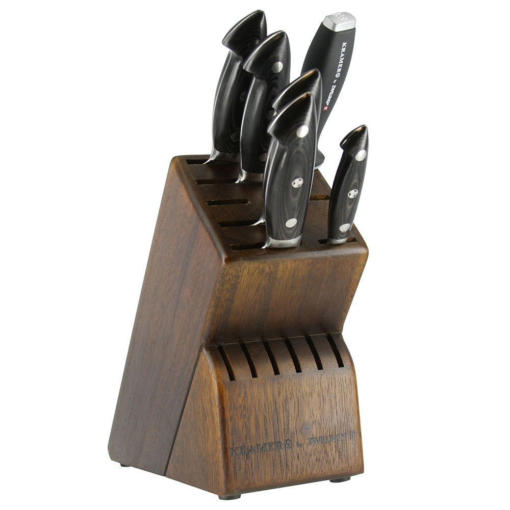 Wooden knife block with six dark handle stainless knives, upright in slots.