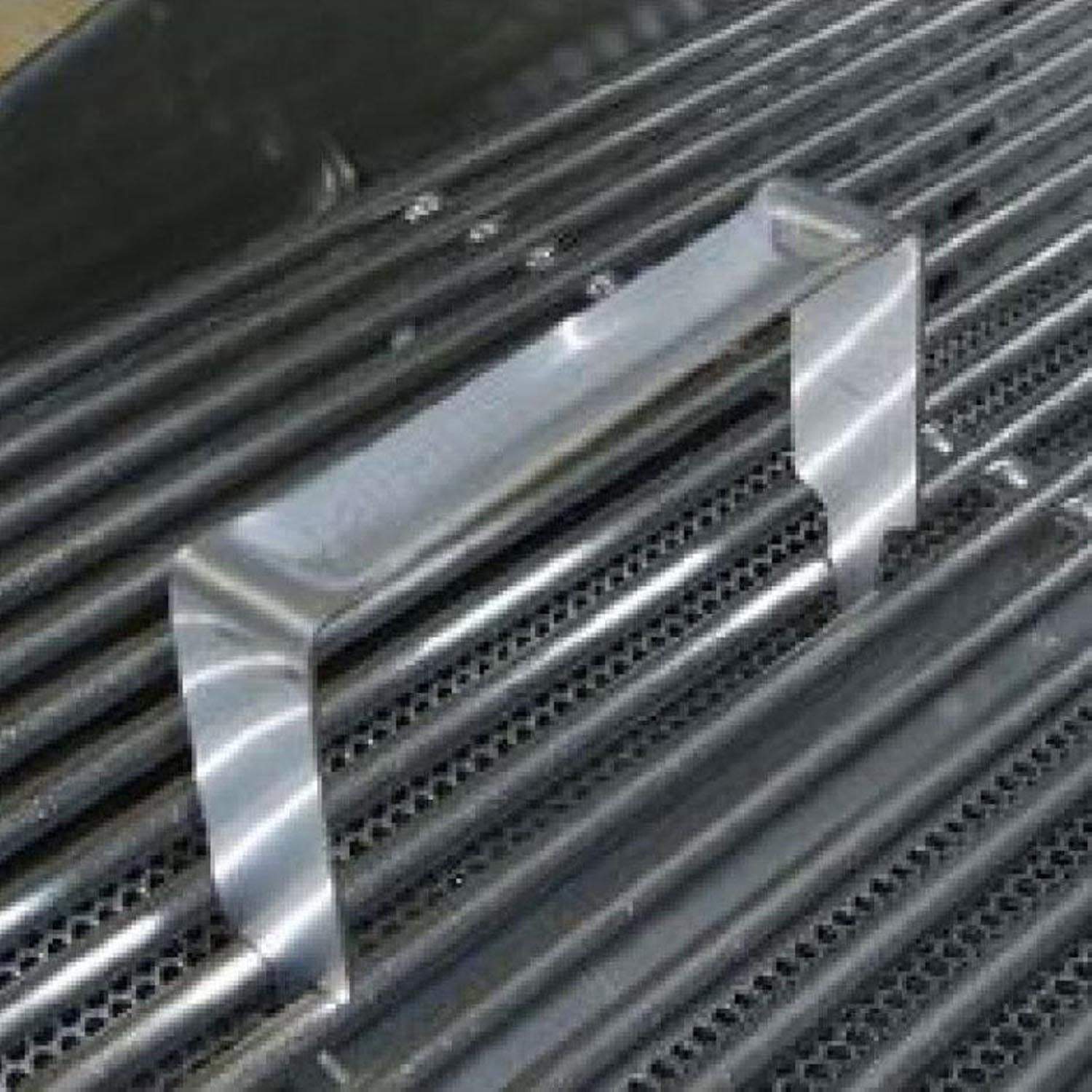 Metal grid lifter resting across smoker grate bars with side handles