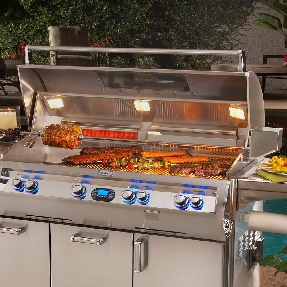 Rotisserie-equipped gas grill with heated spit and food on the rotisserie
