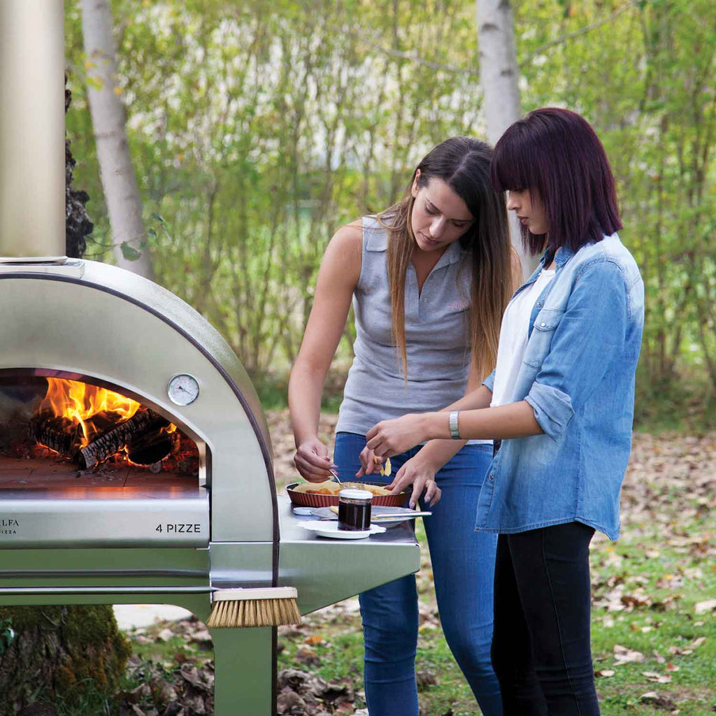 Outdoor wood-fired pizza oven with open dome and pizza peel by the cooking floor