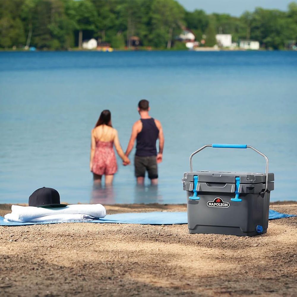 Cooler chest closed with blue carry handle and latch, gray body