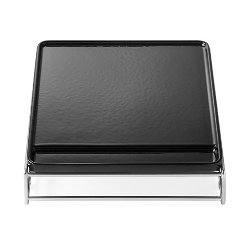Cast iron griddle plate with black surface and chrome support, front view