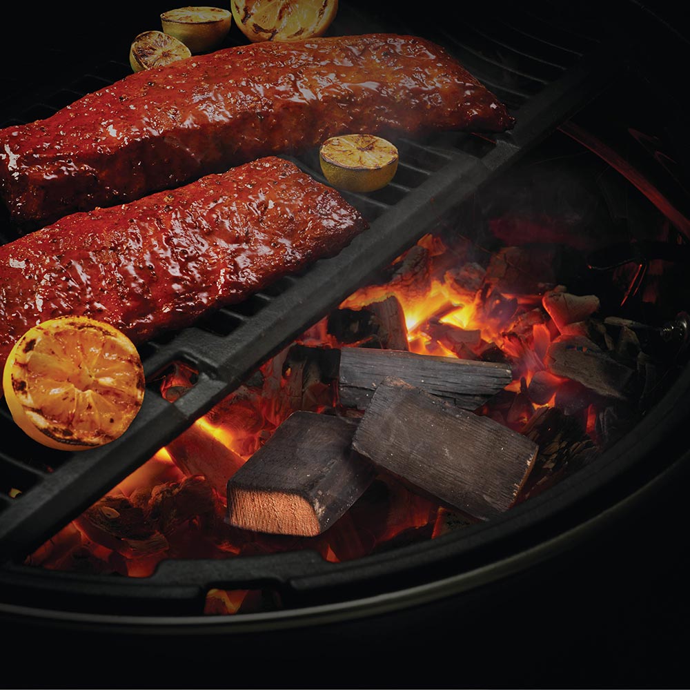 Brandy barrel wood chunks on lit grill with glowing fire