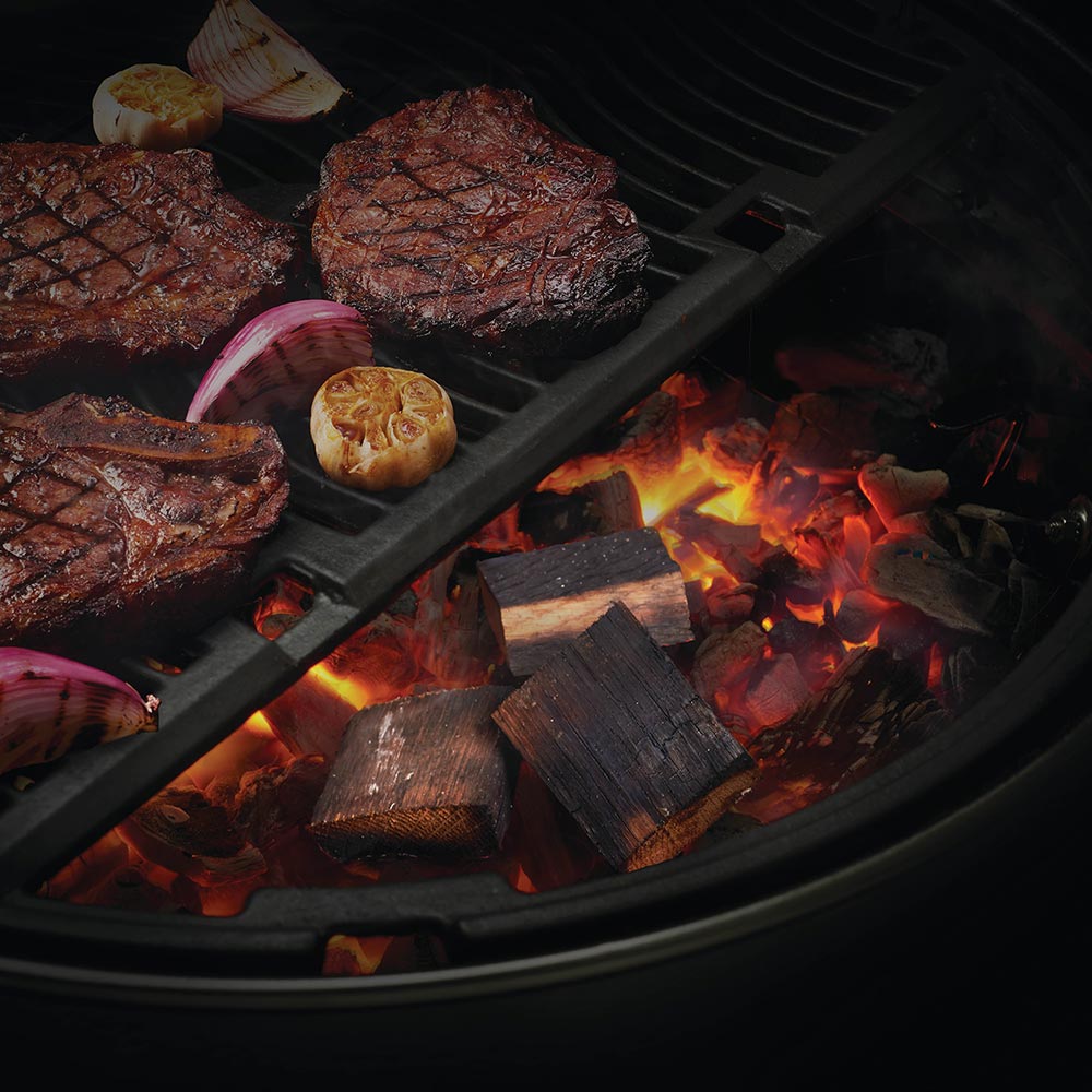 Whiskey barrel wood chunks burning on grill with glowing embers