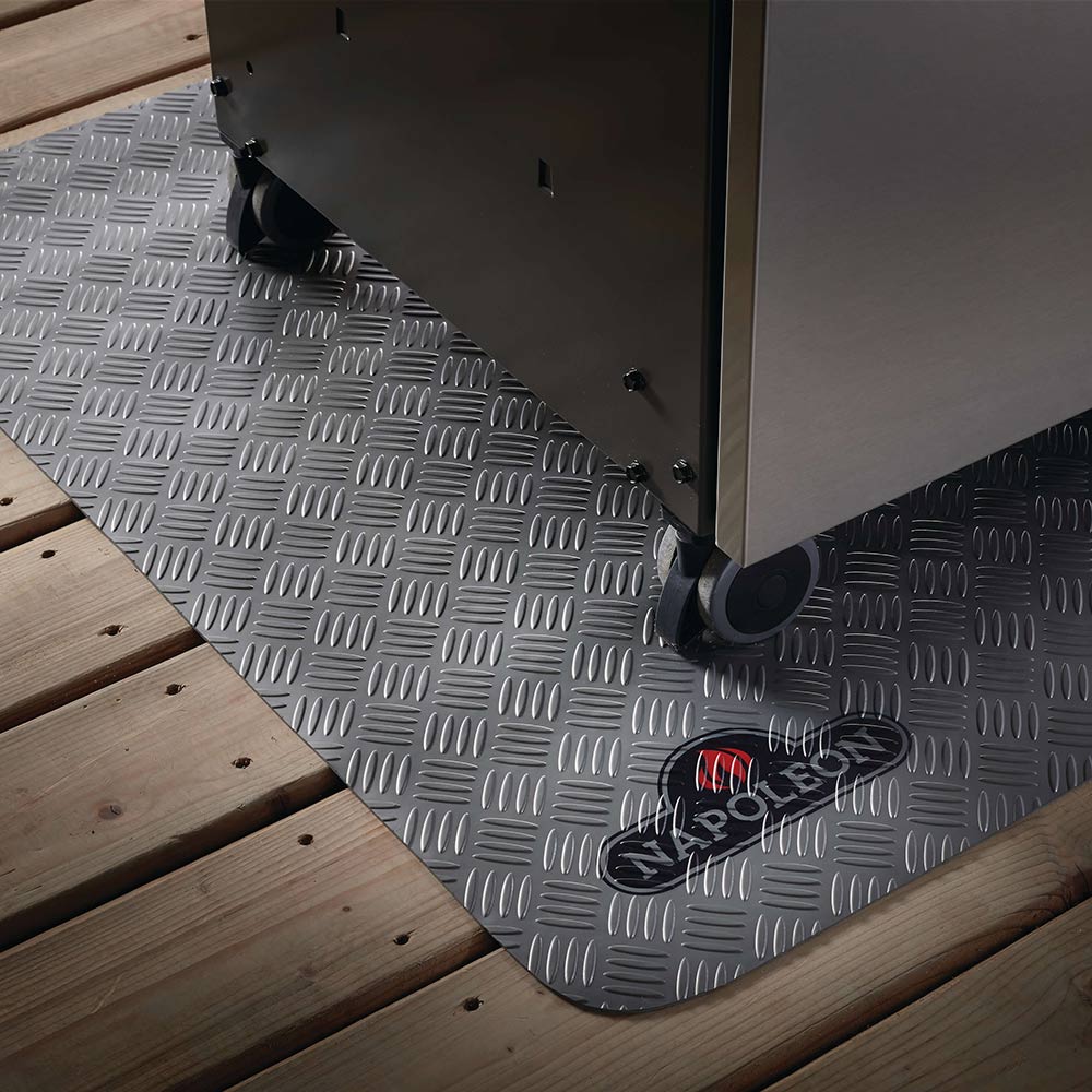 Large grill mat in gray diamond-plate finish with corner clips on wood deck