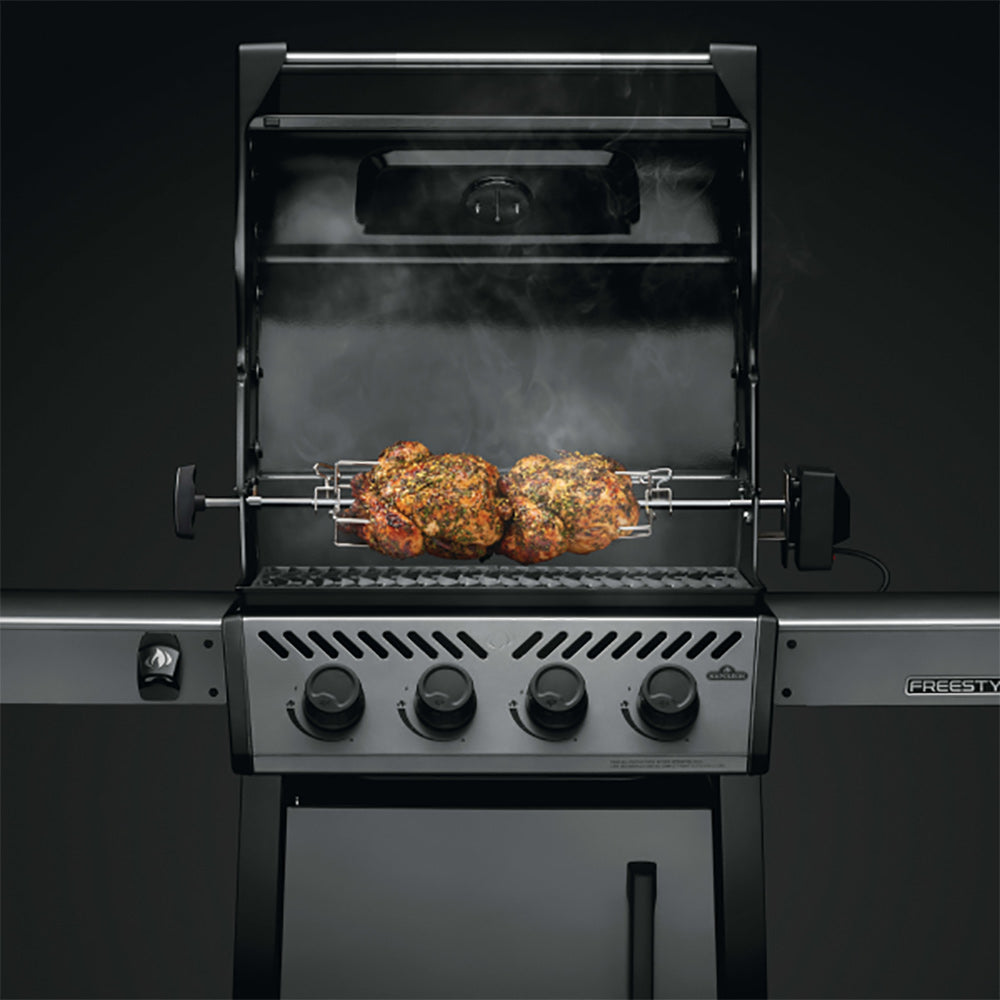 Rotisserie spit with two meat roasts on grill, lid open