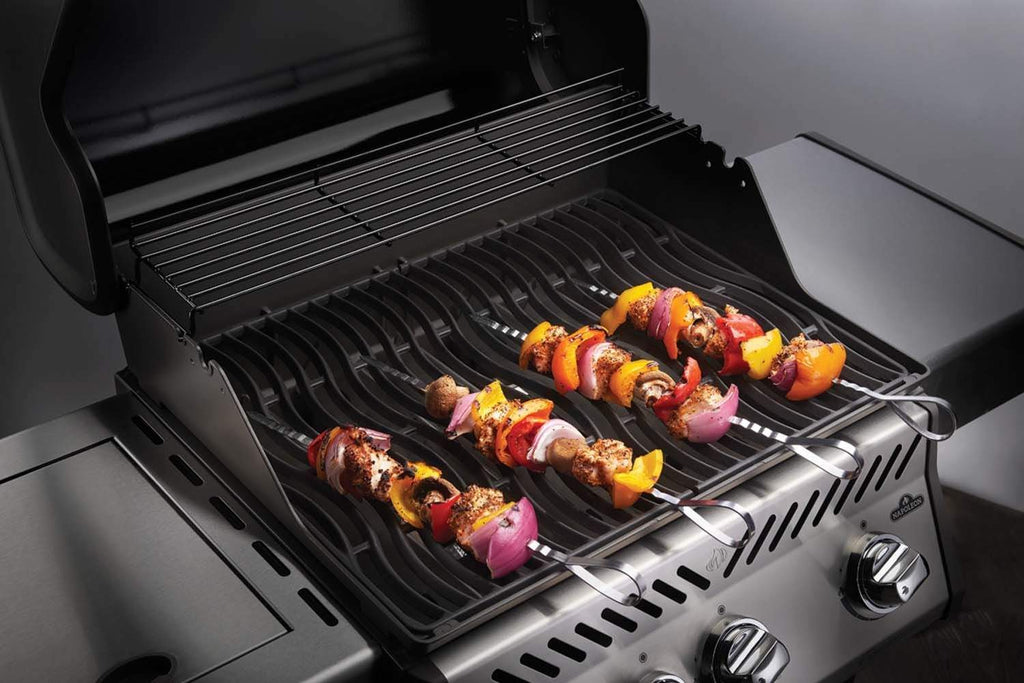 Stainless steel skewers on grill grates, skewered ingredients with loop handles