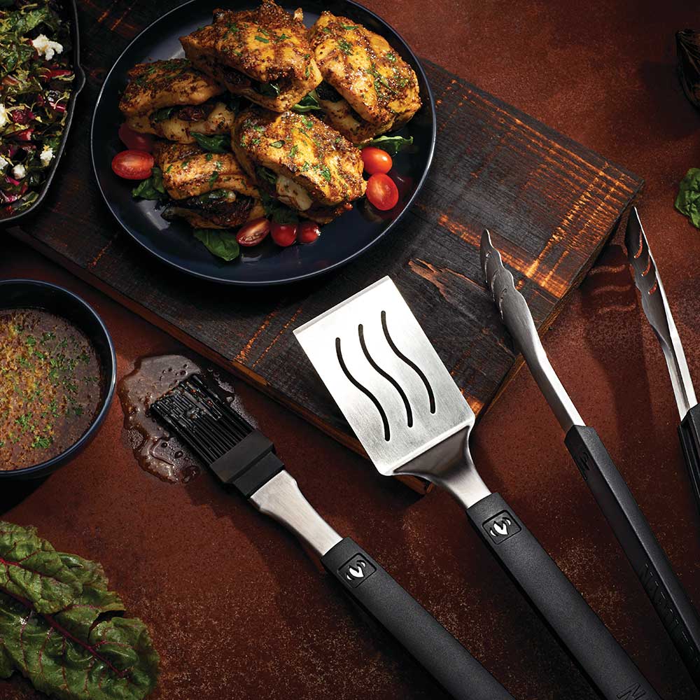 BBQ spatula and tongs with black handles and stainless heads
