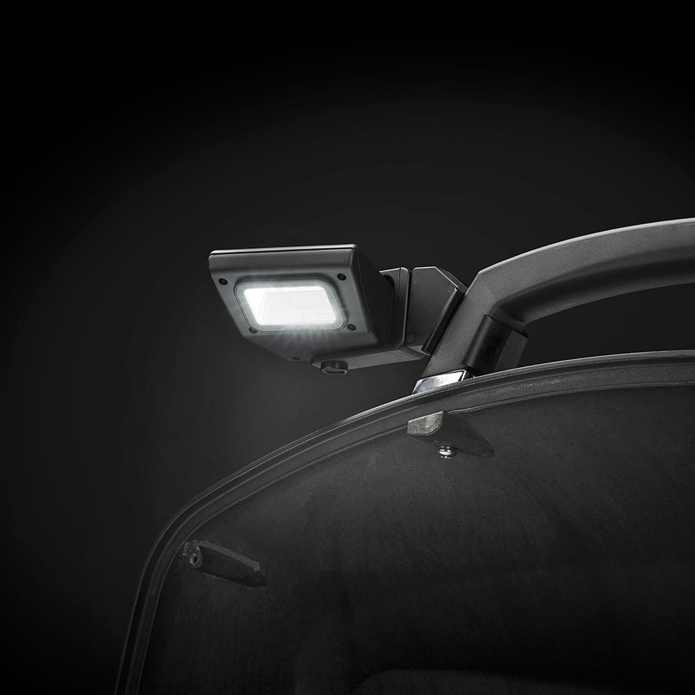 LED light mounted near black grill lid handle and curved top frame