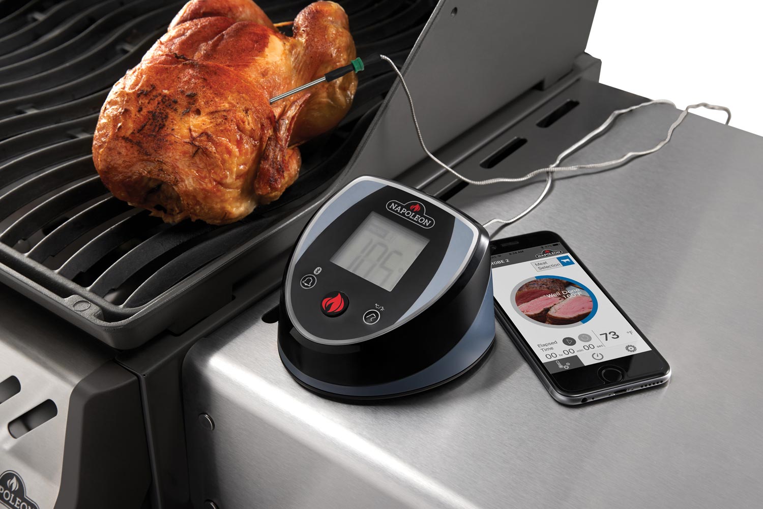 Bluetooth thermometer with digital display and temperature probe cable on grill