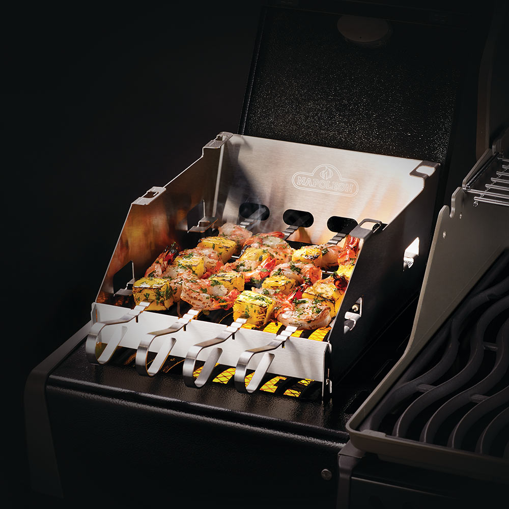 Stainless side burner windbreak and skewer rack, open front, holding skewers with food