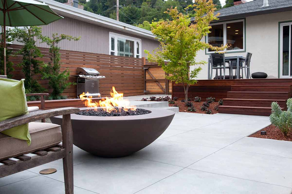 American Outdoor gas grill, round dark fire bowl with flames