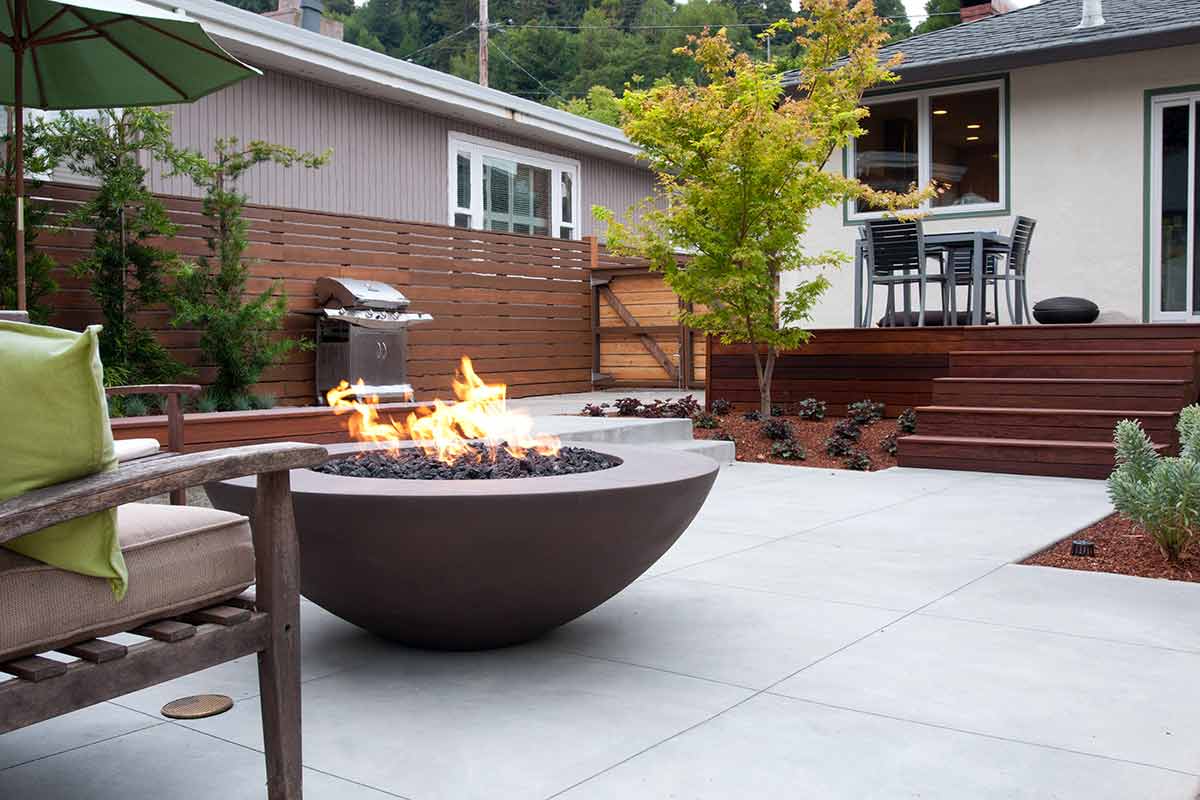 American Outdoor gas grill, round dark fire bowl with flames