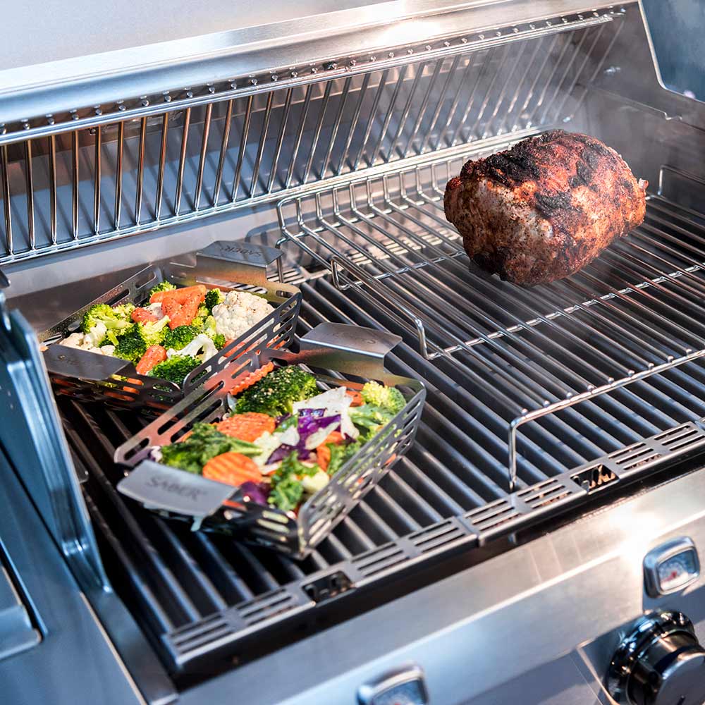 Roasting rack wire grate with roasted meat and vegetables on a grill