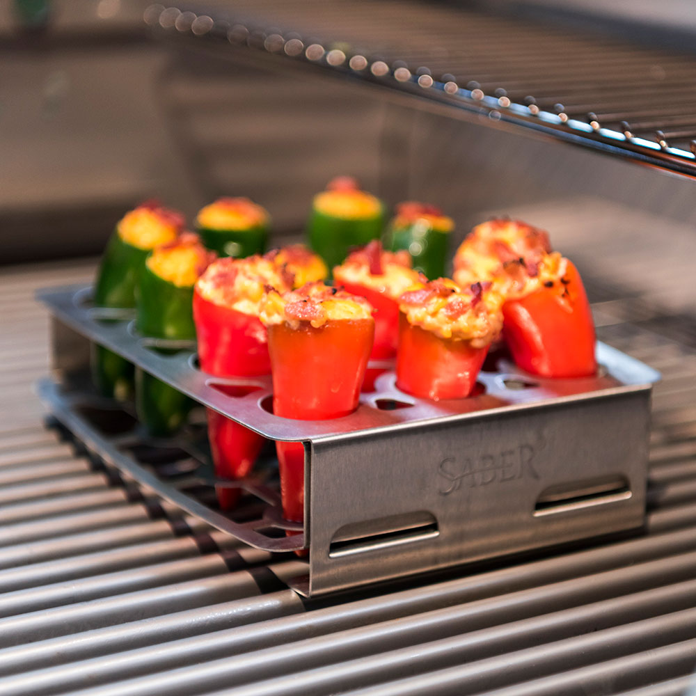 Stainless steel double pepper roaster holding red and green stuffed peppers