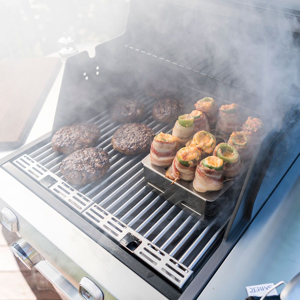 Double pepper roaster tray on grill holding stuffed bites with smoke