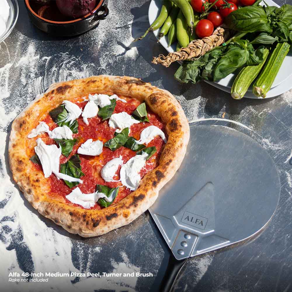 Alfa pizza peel with perforated metal surface under a topped pizza