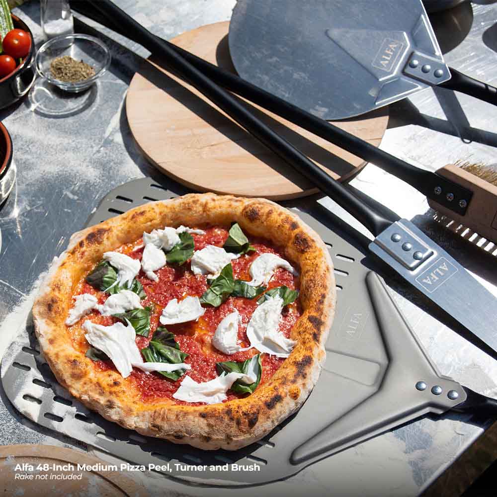 Alfa pizza turner and peel with topped pizza and matching brush
