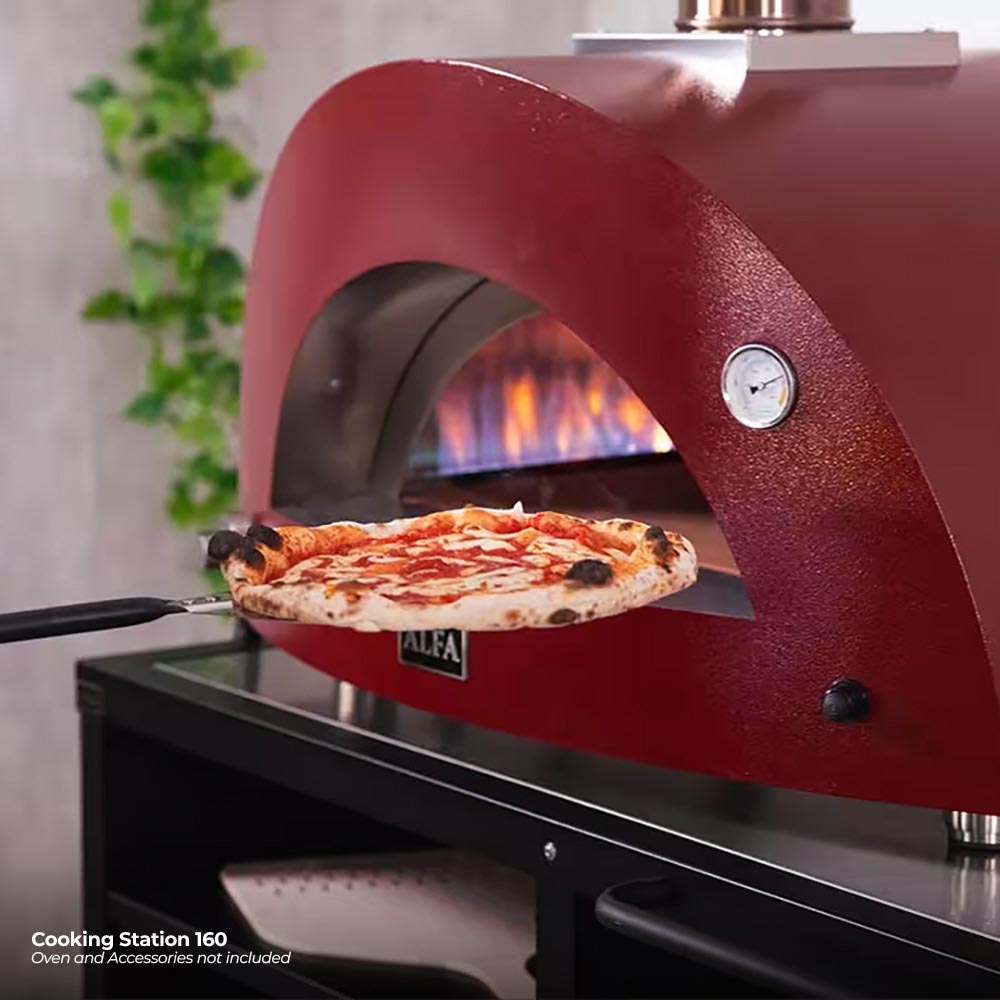 Outdoor pizza oven on cooking station with red dome and pizza on stone