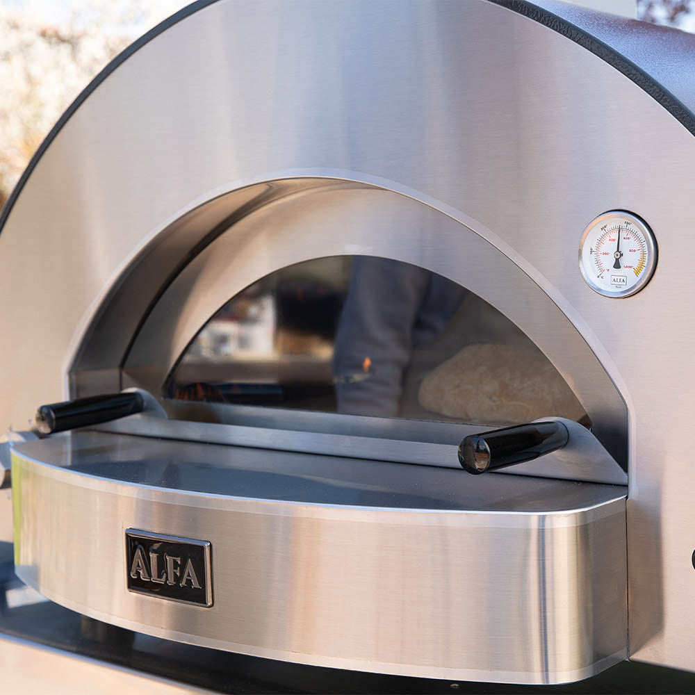 Front view of stainless steel pizza oven dome with thermometer on the arch