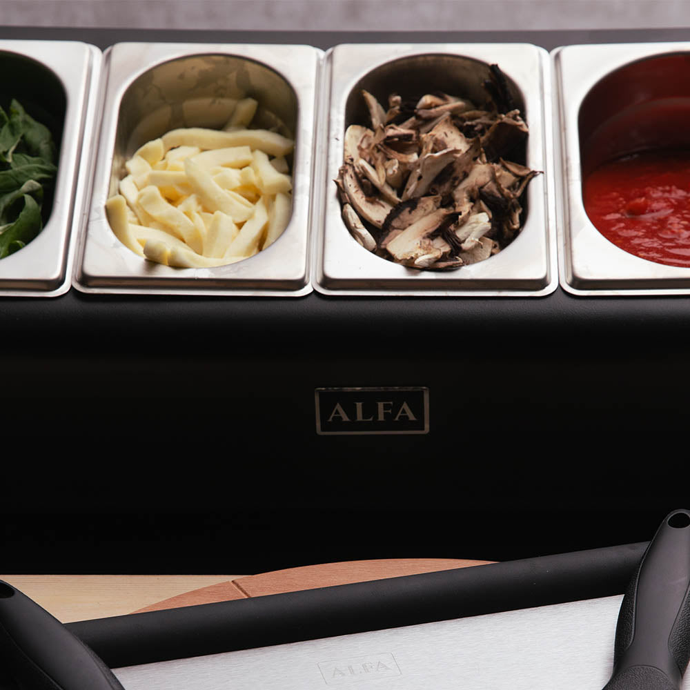 Alfa topping station close-up with four stainless wells and black serving scoops