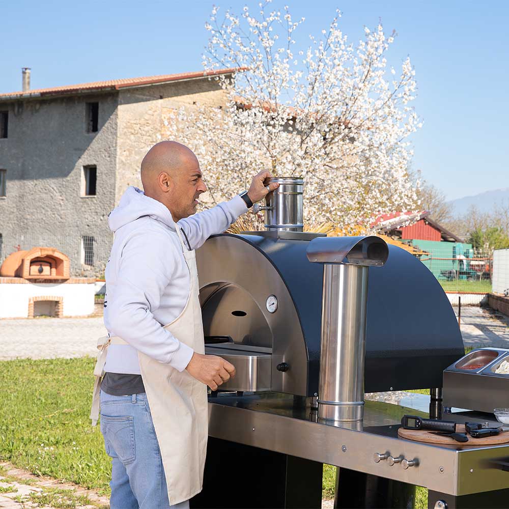 Stainless steel chimney flue with adjustable damper valve on outdoor pizza oven