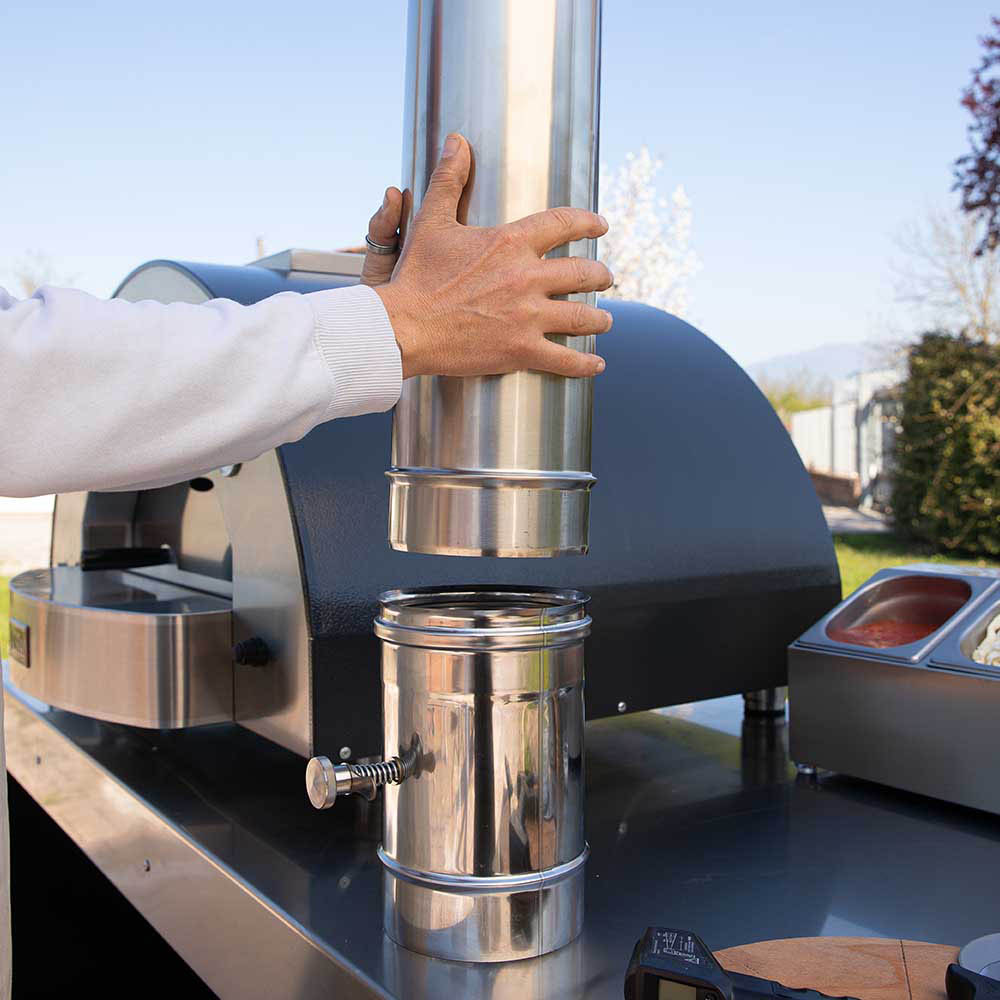 Stainless steel chimney flue with damper valve section on outdoor pizza oven