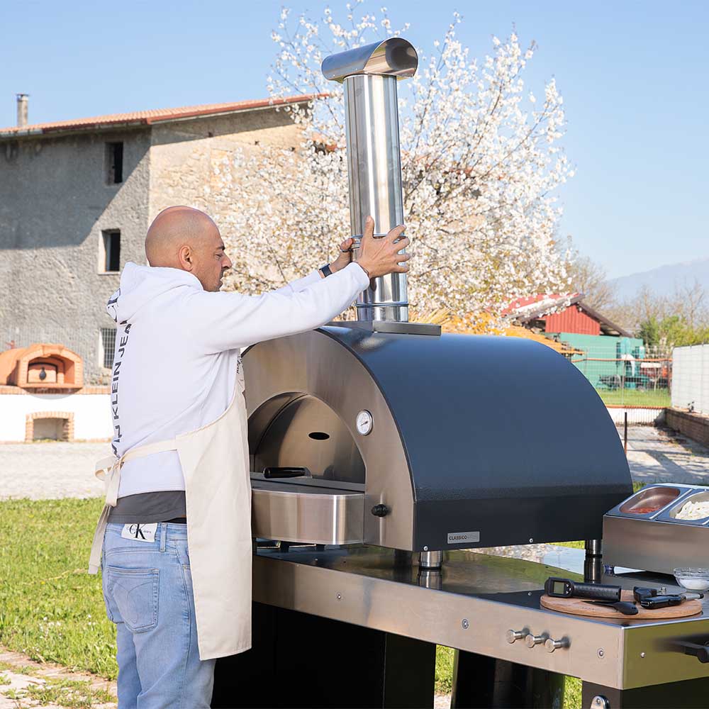 Stainless steel chimney flue with butterfly damper valve on outdoor pizza oven