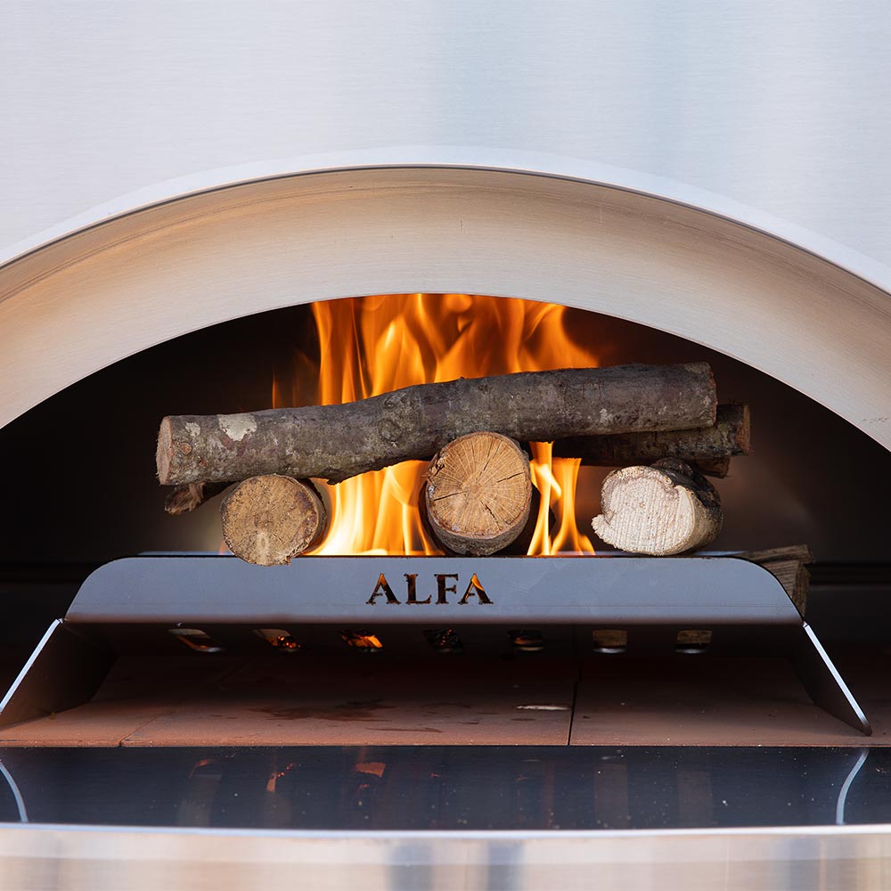 Alfa pizza oven chamber with burning logs and glowing flames under the cooking hood