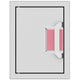 Paper towel dispenser with pink paper towels in wall-mount opening