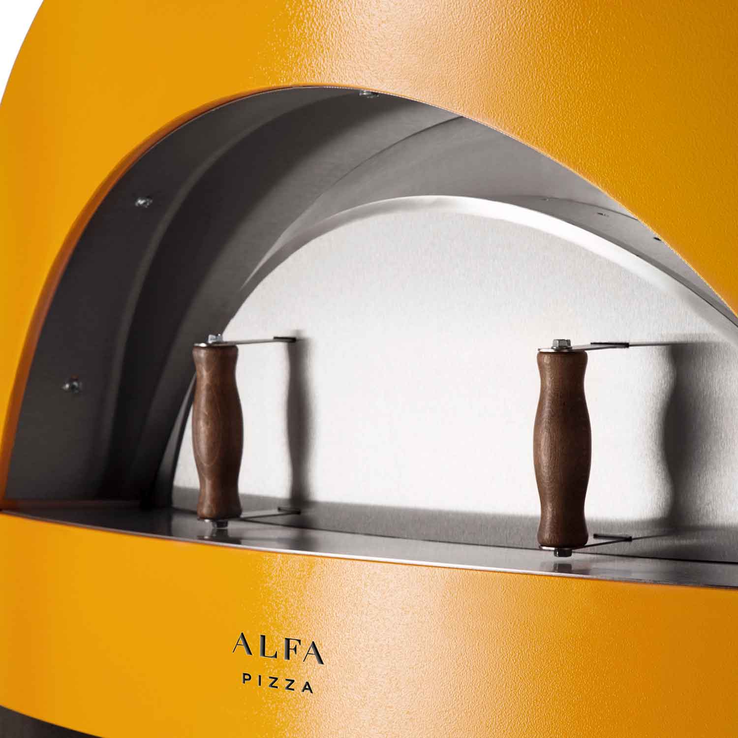 Yellow oven cooking chamber with arched front and two brown-handled tools