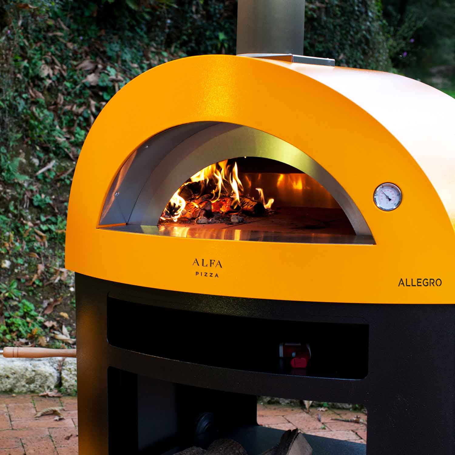 Fire yellow countertop wood-fired pizza oven with open arch and visible flames inside