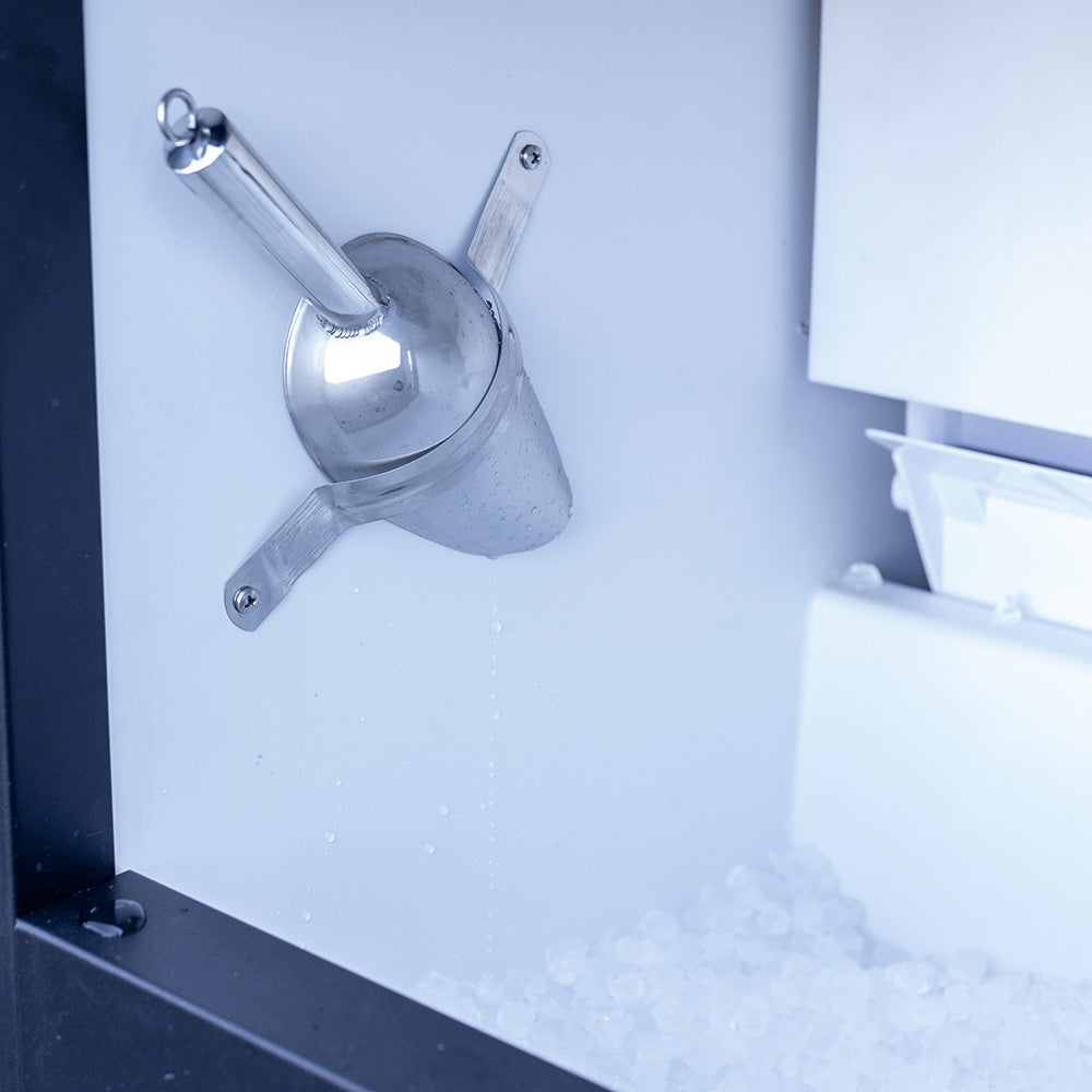 Nugget ice chute and ice bin with scattered ice