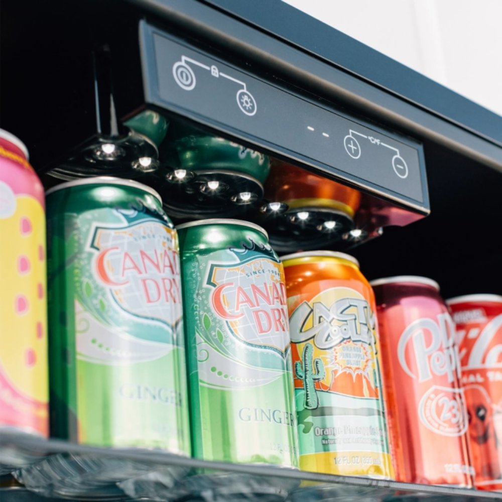 Refrigerator interior with colorful canned drinks and digital control panel