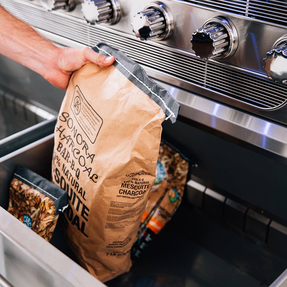 Bag of natural wood grill fuel in open storage drawer