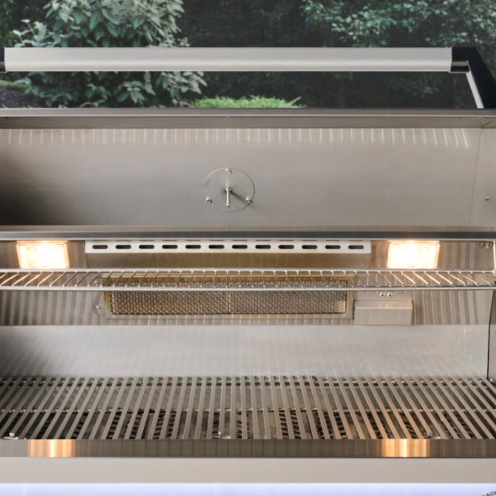 Open built-in gas grill showing main burners and empty cooking grates