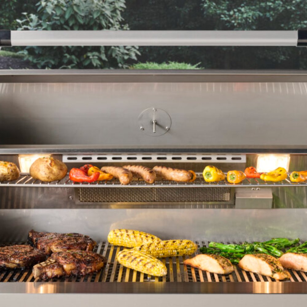 Built-in gas grill interior with cooking grates and assorted grilled vegetables