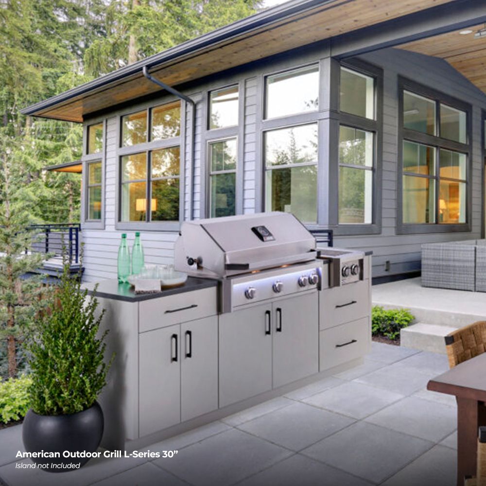 Stainless outdoor gas grill with closed hood and four blue-ring control knobs