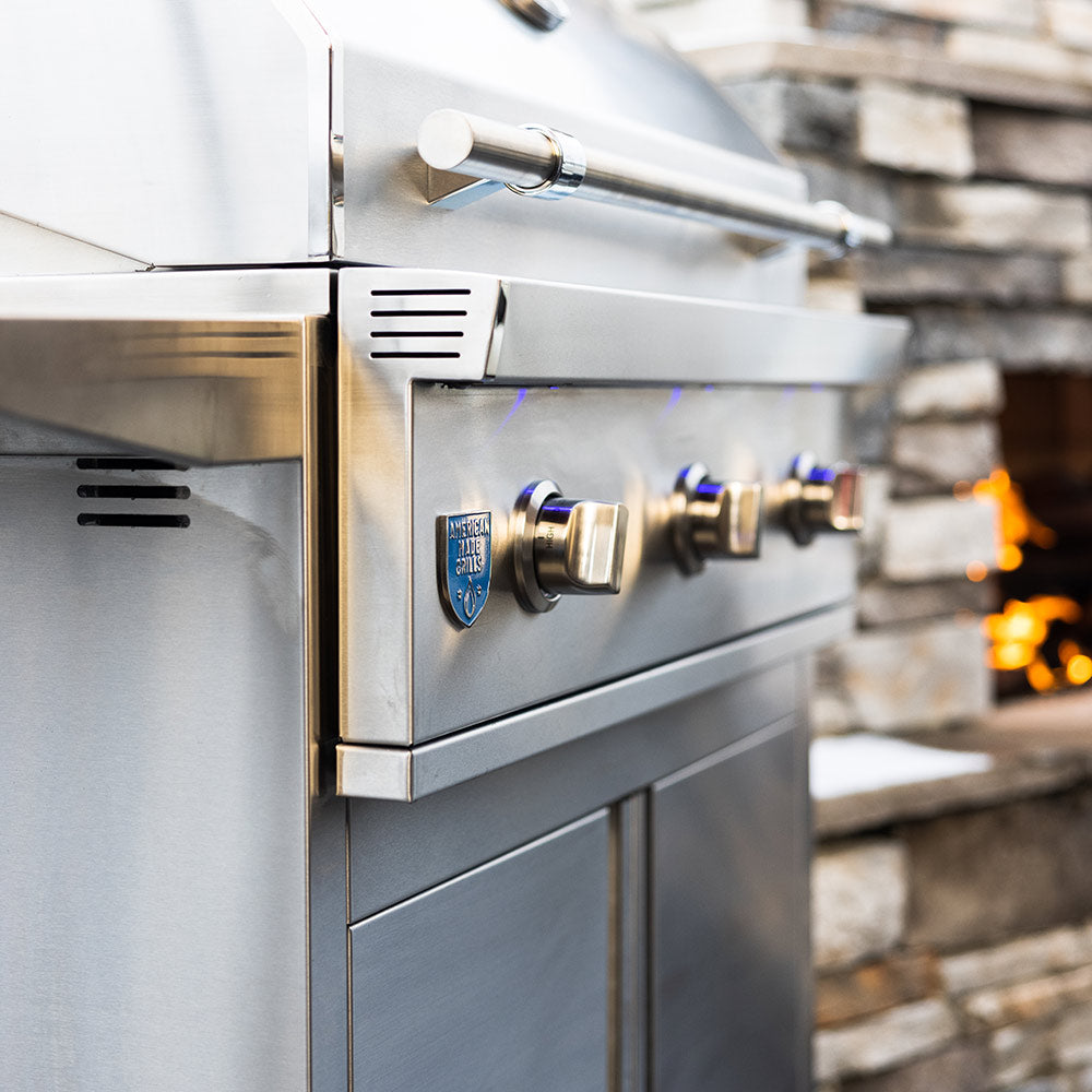 Stainless steel gas grill control panel with knob and ignition hardware, side view