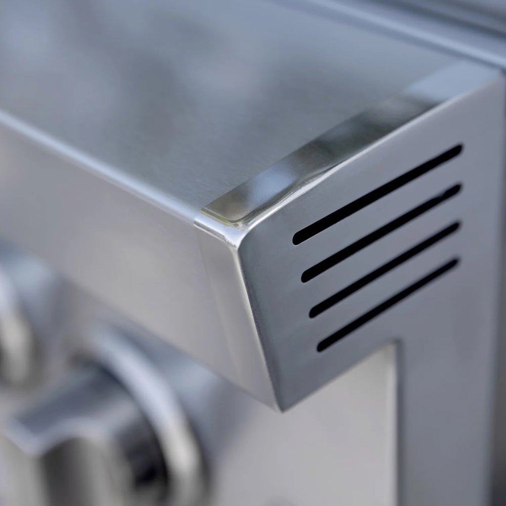 Stainless steel corner control panel with black slotted vent opening