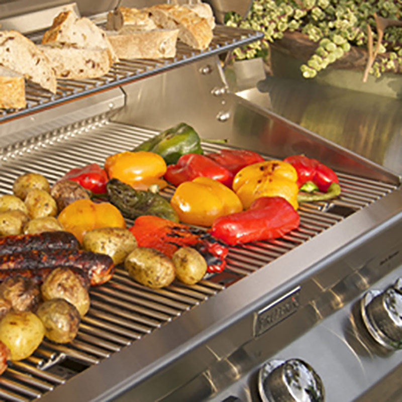 Stainless steel gas grill cooking grate with peppers, sausages, and vegetables