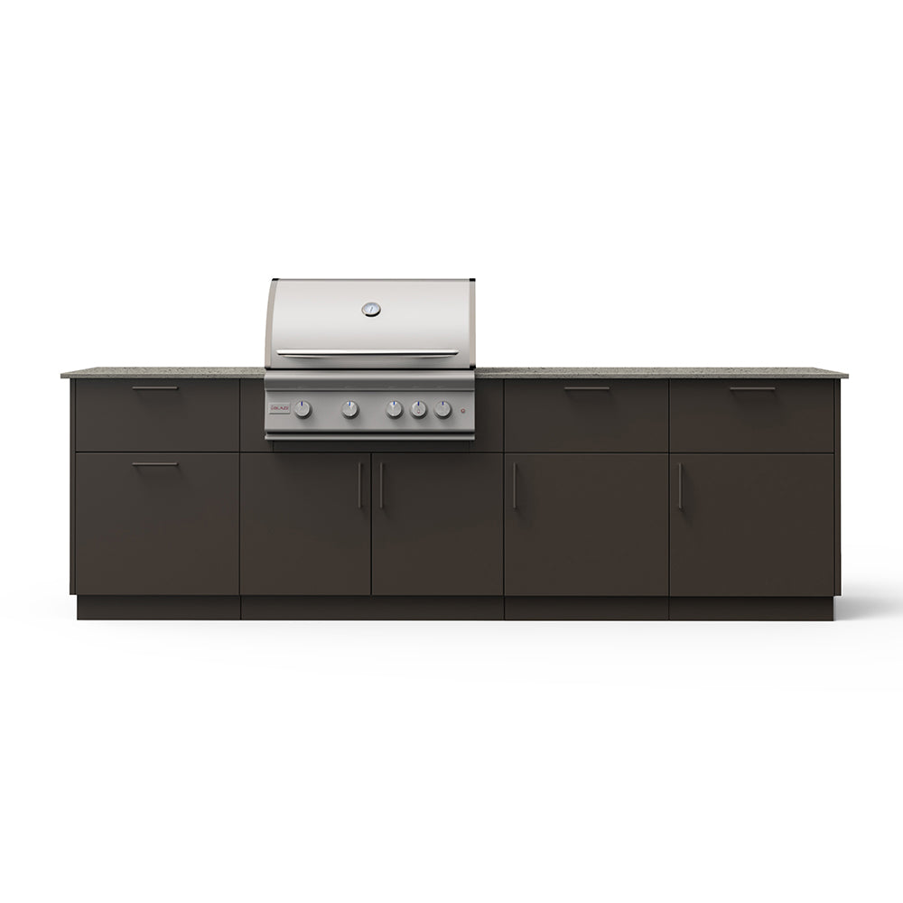 Outdoor kitchen island with built-in grill, dark cabinet doors, beige countertop view