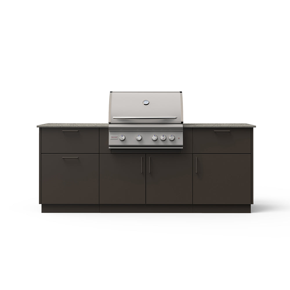 Outdoor kitchen island with built-in grill, dark cabinet doors, gray speckled countertop.