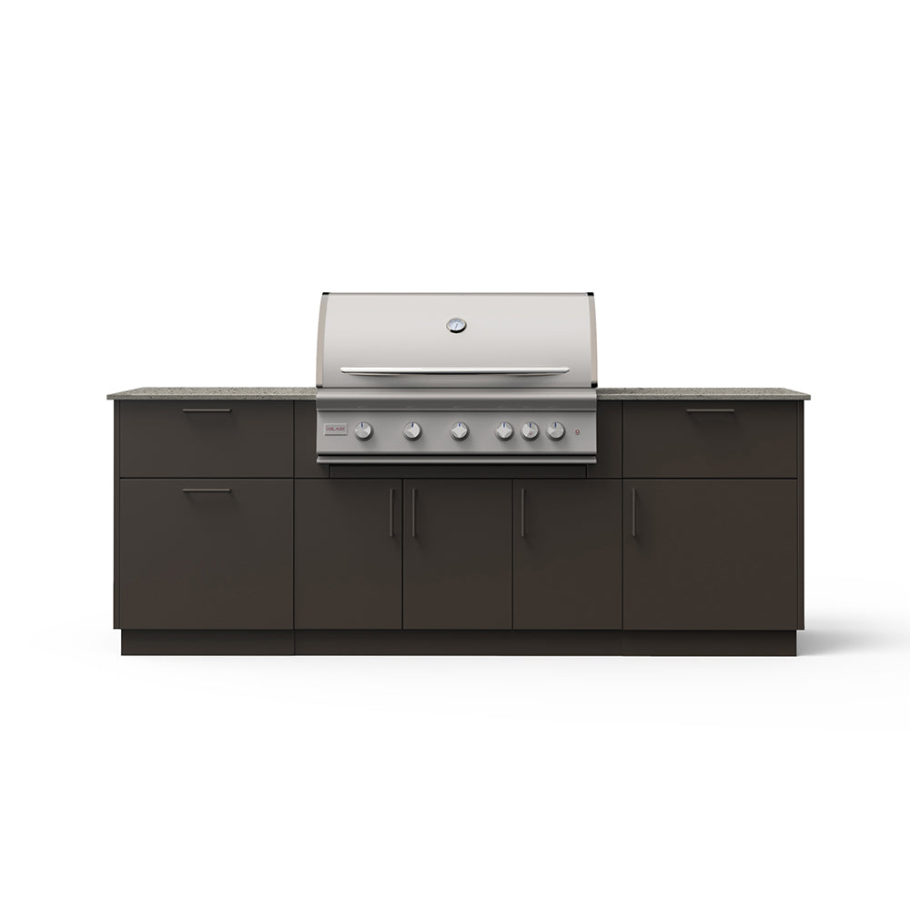 Outdoor kitchen island with stainless grill and dark cabinets, light beige countertop.